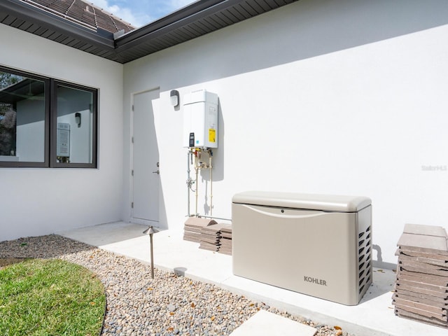 view of exterior entry with water heater and stucco siding