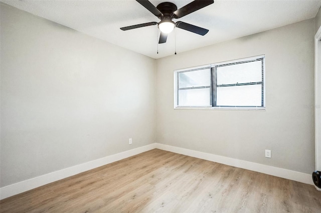 spare room featuring ceiling fan, wood finished floors, and baseboards