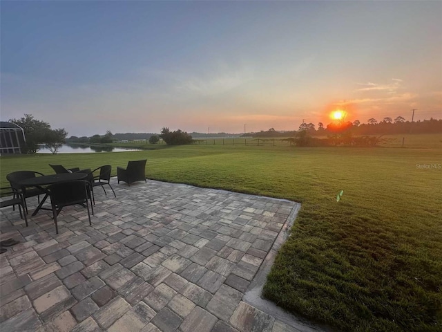 view of patio / terrace with a water view and a rural view