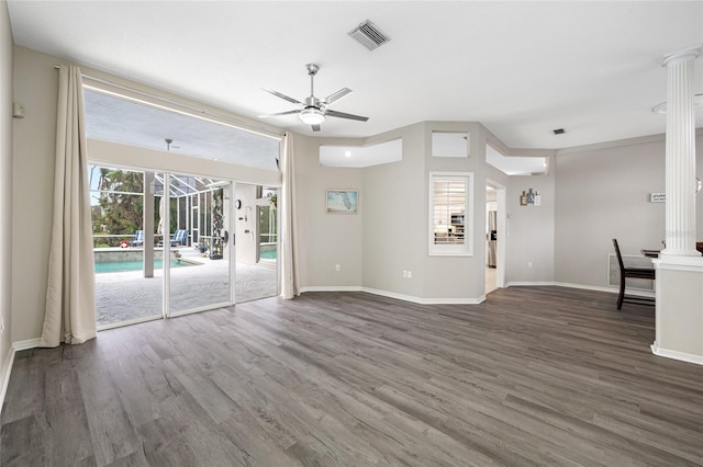 unfurnished living room with visible vents, wood finished floors, a ceiling fan, and baseboards