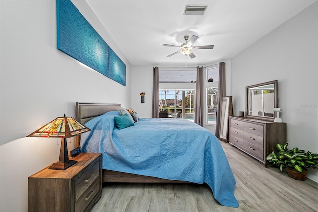 bedroom with a ceiling fan, visible vents, and light wood finished floors