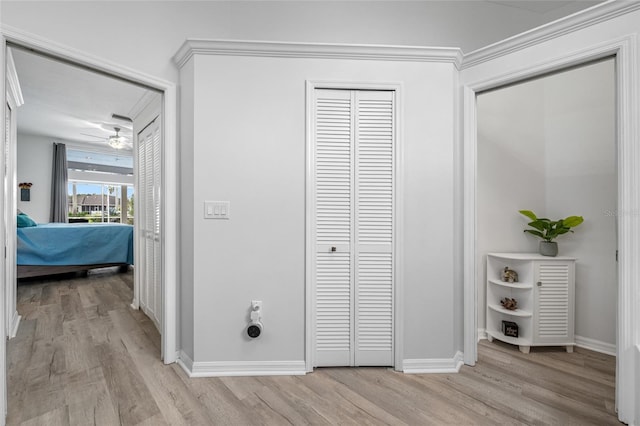 hallway with light wood-style floors and baseboards