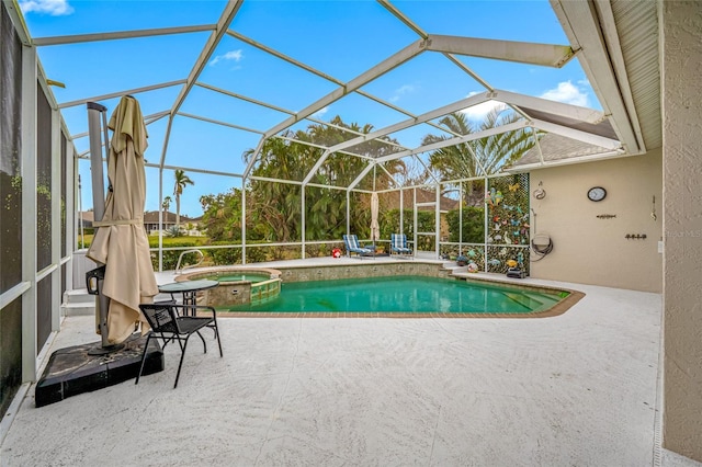 view of swimming pool featuring a pool with connected hot tub, a patio, and a lanai