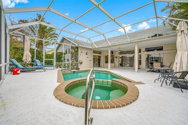 view of swimming pool with a lanai, a pool with connected hot tub, and a patio