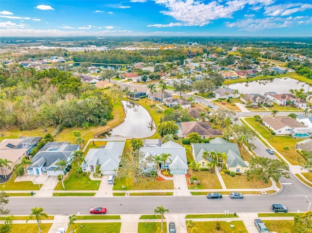 drone / aerial view featuring a residential view and a water view