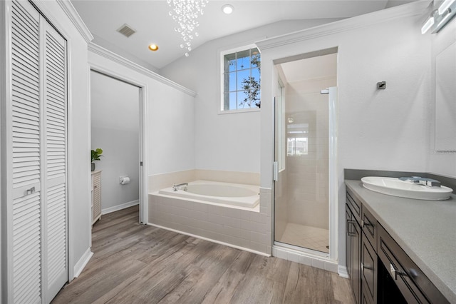 bathroom featuring vaulted ceiling, a stall shower, a closet, and visible vents