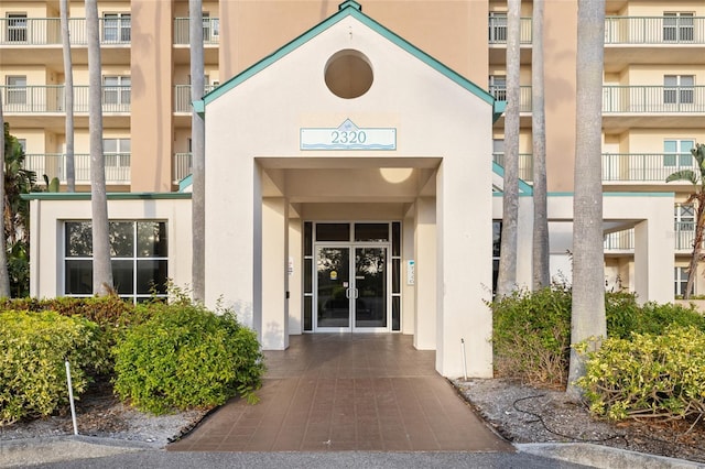 entrance to property featuring stucco siding