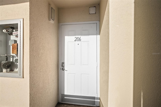 doorway to property with stucco siding