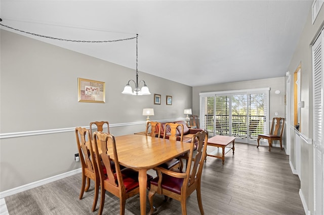 dining room with an inviting chandelier, wood finished floors, and baseboards