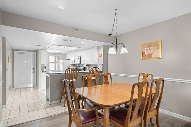 dining room featuring light tile patterned floors, recessed lighting, and baseboards