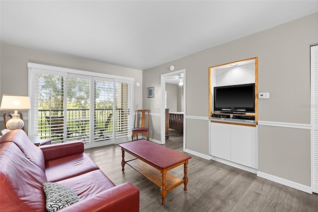 living room with baseboards and wood finished floors