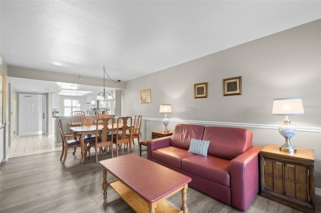 living area featuring a textured ceiling and wood finished floors