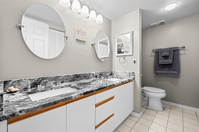 full bath with tile patterned flooring, double vanity, visible vents, and a sink