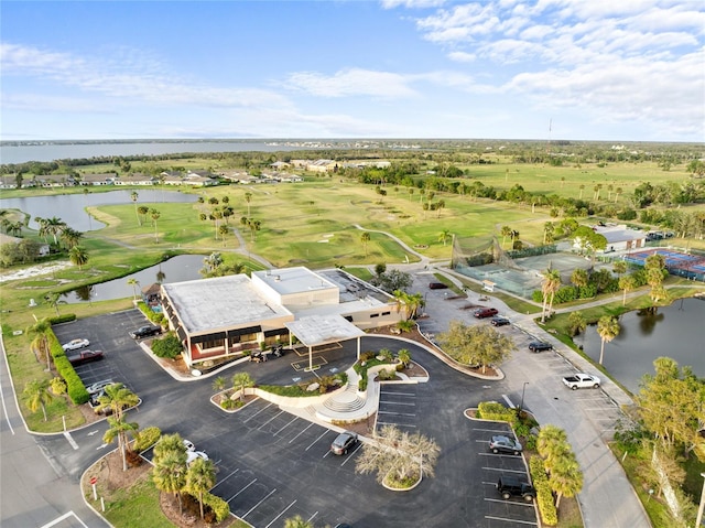 drone / aerial view featuring view of golf course and a water view