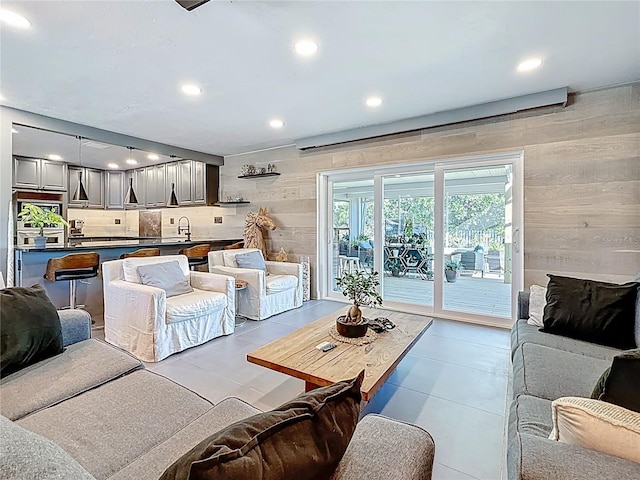 living area featuring wooden walls and recessed lighting