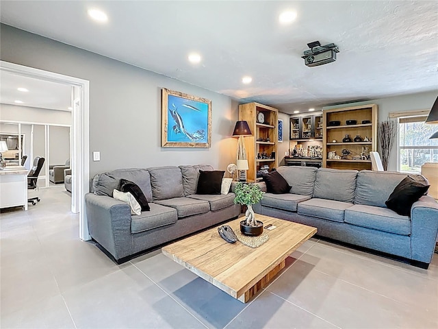 living area with light tile patterned floors and recessed lighting