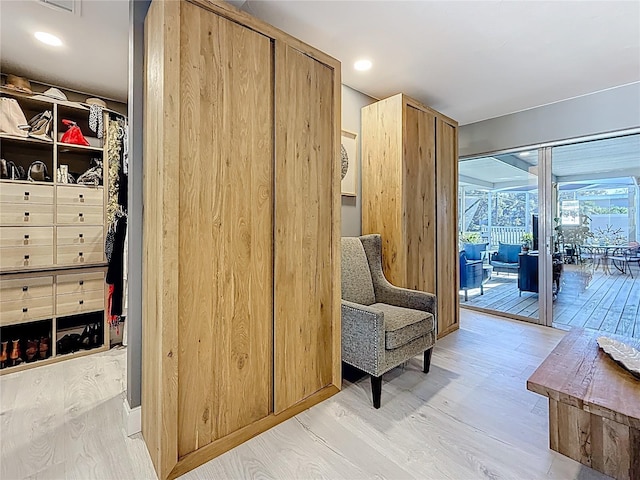 interior space featuring light wood-type flooring and a sunroom