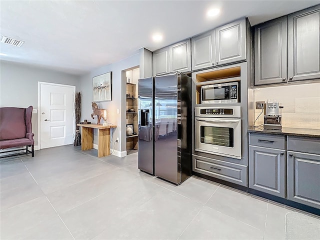 kitchen with visible vents, dark countertops, appliances with stainless steel finishes, gray cabinetry, and recessed lighting