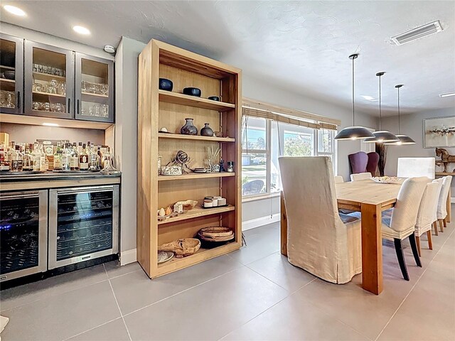 tiled dining space featuring wine cooler, recessed lighting, visible vents, baseboards, and a dry bar