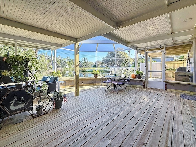 sunroom featuring beam ceiling