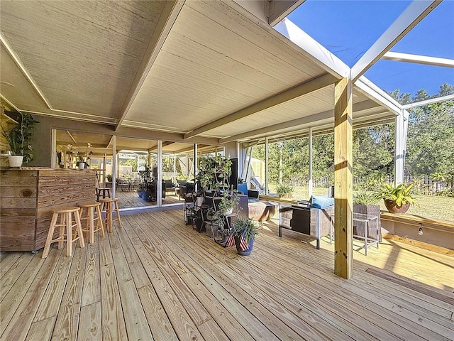 wooden terrace with a lanai and outdoor dry bar