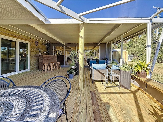 wooden terrace with outdoor dry bar and outdoor lounge area