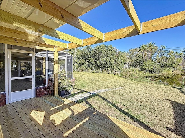 wooden terrace featuring a yard and a pergola