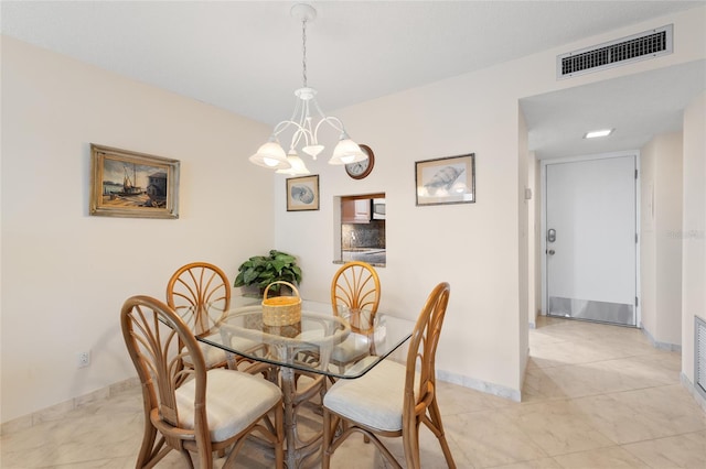 dining space with visible vents, baseboards, and an inviting chandelier