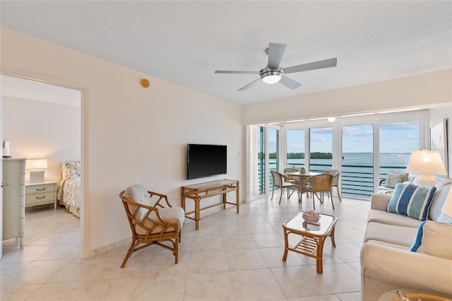 living room with light tile patterned floors and a ceiling fan