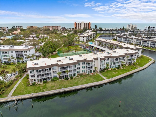 drone / aerial view featuring a city view and a water view