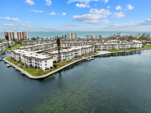 birds eye view of property featuring a water view and a view of city