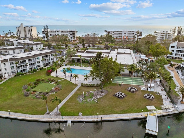 birds eye view of property with a view of city and a water view