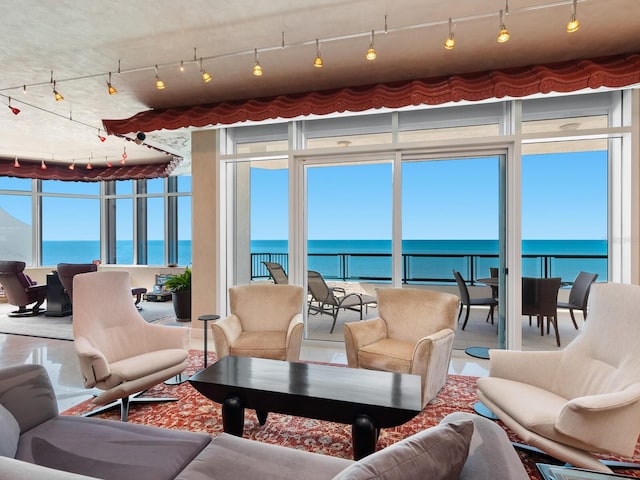 sunroom featuring a water view