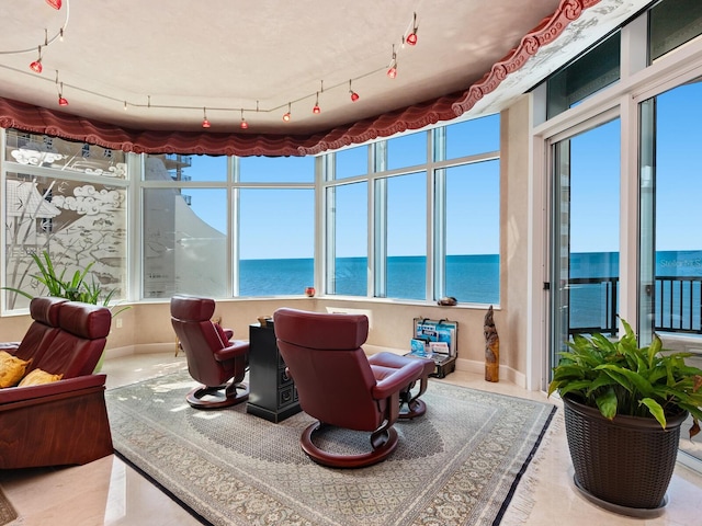 sunroom / solarium with a water view and plenty of natural light