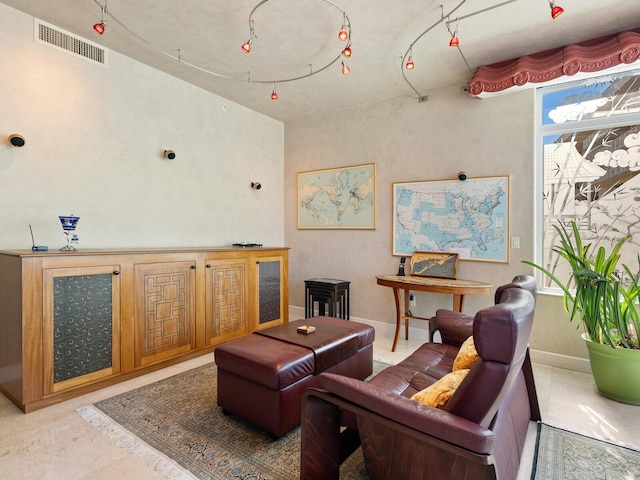 living room with baseboards and visible vents