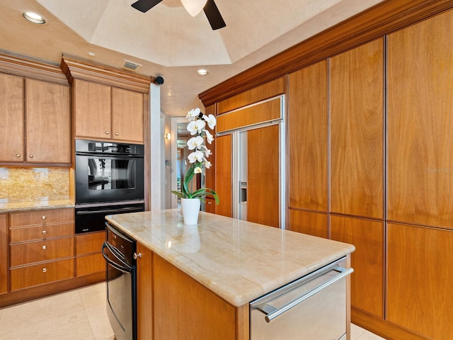 kitchen with a warming drawer, light stone counters, tasteful backsplash, a center island, and light tile patterned flooring