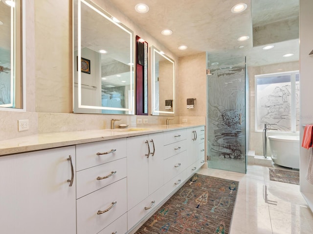 full bath with vanity, a marble finish shower, a soaking tub, recessed lighting, and decorative backsplash