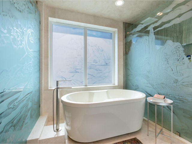 full bath featuring a soaking tub, a shower, and tile patterned floors