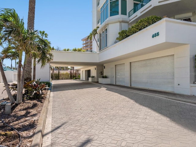 exterior space with stucco siding and decorative driveway