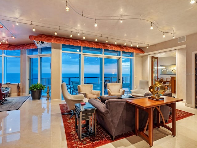 living room featuring visible vents and a water view