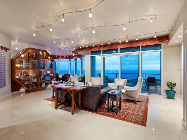 living room with rail lighting and a water view