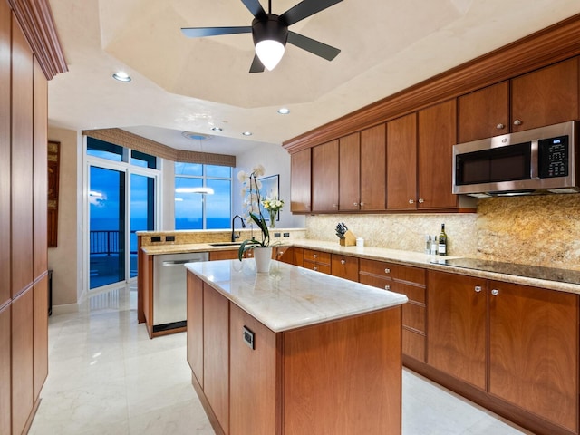 kitchen featuring backsplash, a center island, recessed lighting, stainless steel appliances, and a peninsula