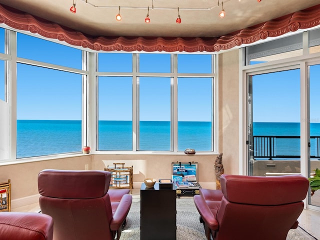 interior space featuring a water view and rail lighting