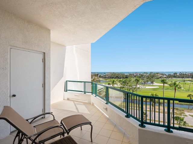 balcony with a water view and golf course view