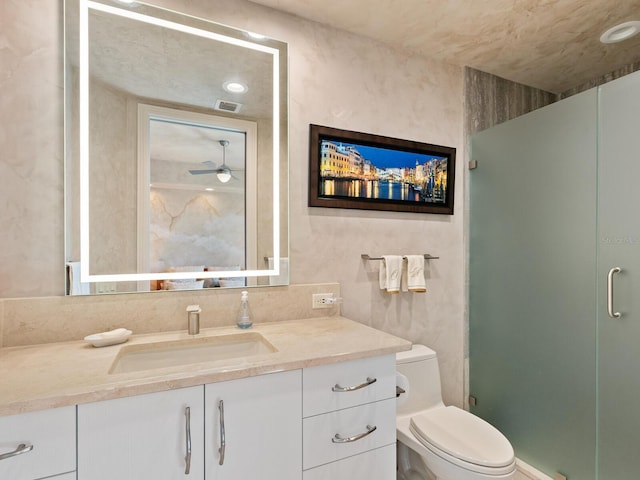 full bath with visible vents, vanity, a shower stall, and toilet