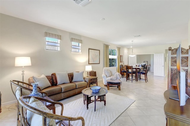 living room with visible vents, baseboards, and light tile patterned flooring