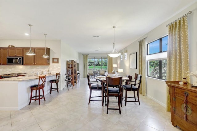 dining area with baseboards and visible vents