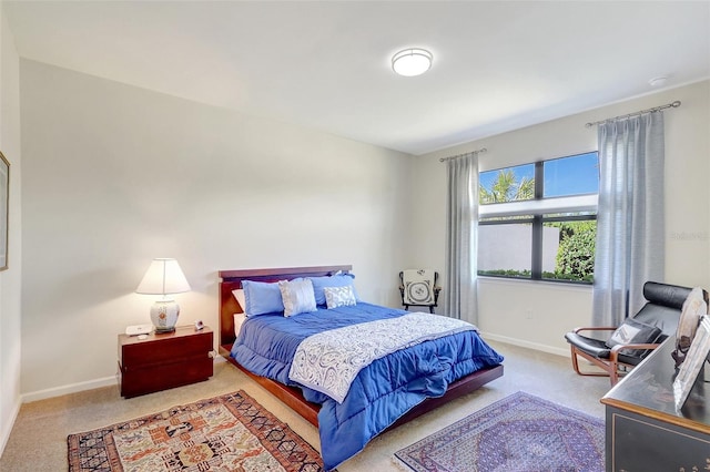 carpeted bedroom featuring baseboards