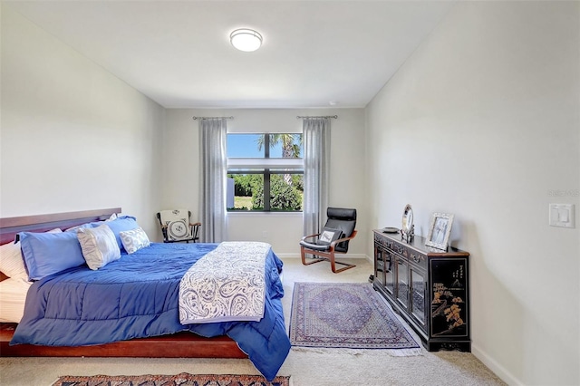 carpeted bedroom featuring baseboards