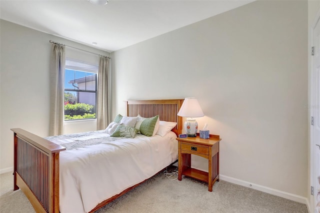 bedroom with carpet and baseboards